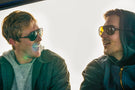 MATTEBROWN_YELLOW Two guys talking wearing pairs of Ombraz classic armless string sunglasses