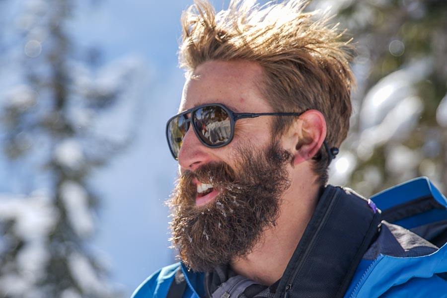 charcoal_yellow Bearded man in the snow wearing Ombraz classic armless sunglasses with cord