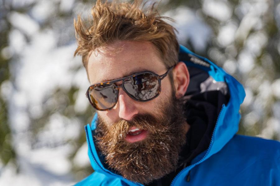 Tortoise_brown Bearded man in the snow wearing Ombraz classic armless sunglasses with cord