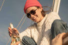 Tortoise_brown Woman enjoying a bottle of white wine wearing Ombraz classic armless strap sunglasses