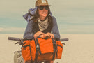 charcoal_brown Woman biking in the sand wearing Ombraz classic armless rope sunglasses