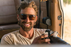 ember_brown Photographer in car wearing Ombraz leggero ember brown armless string sunglasses