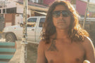 leggero_charcoal_grey Tattooed man with long hair sporting Ombraz leggero armless string sunglasses