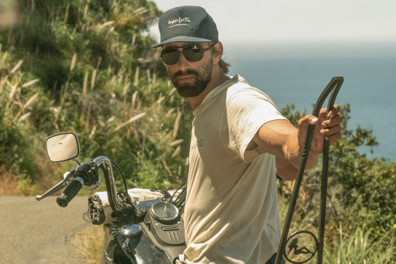 ember_brown Man on a motorcycle wearing Ombraz leggero armless sunglasses with cord 