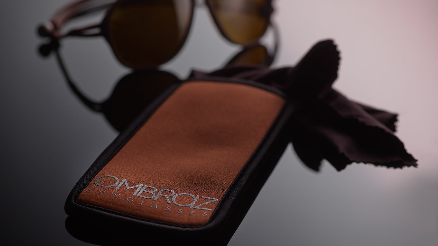 Neoprene Case with Built-In Microfiber - Ombraz solve what frustrates you about sunglasses. Handmade frames attach directly to an adjustable cord that keeps the sunglasses securely & comfortably in place. 2019 Sunglass of the year from Backpacker Magazine, Ombraz are lightweight, easy to pack & stow & are equipped with world-class polarized Zeiss lenses. Armless sunglasses with a built-in cord.