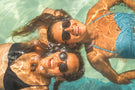 Two girls in a pool wearing Ombraz secure sunglasses with strap TETON_CHARCOAL_brown