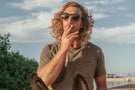 Man smoking wearing Ombraz teton armless rope sunglasses TETON_CHARCOAL_GREY