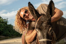 Man smiling next to a donkey wearing Ombraz teton armless sunglasses TETON_TORTOISE_YELLOW