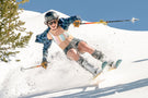 Tortoise_grey Woman skiing downhill in the sun wearing Ombraz classic armless strap sunglasses