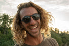 VIALE_DUSK_GREY Man smiling wearing Ombraz viale armless string sunglasses