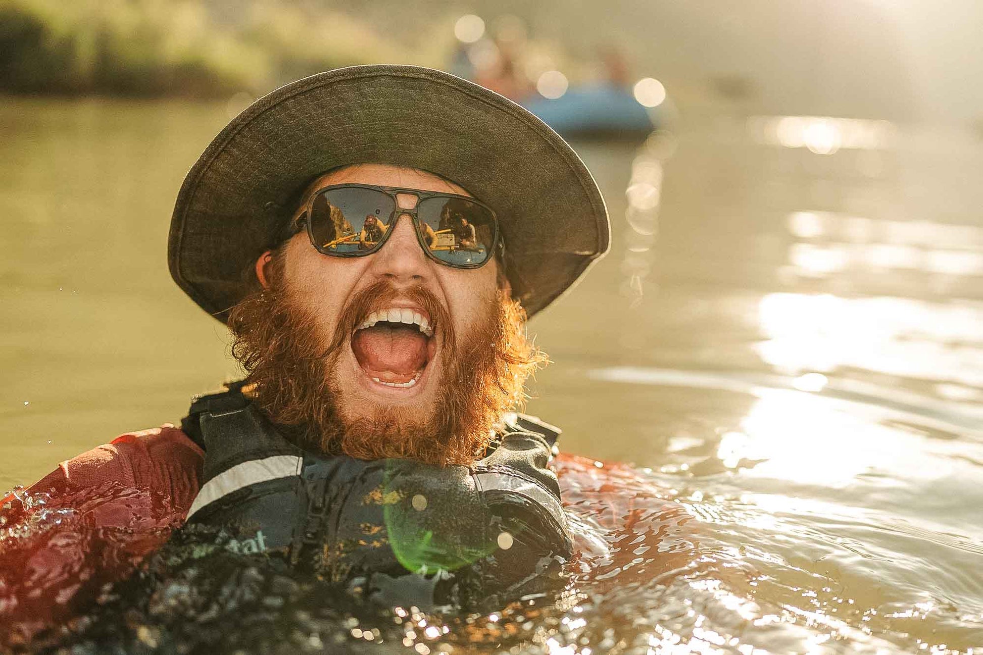 leggero_tortoise_grey Swimming man in a river screaming wearing Ombraz leggero armless string sunglasses